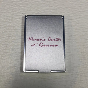 
                  
                    Women’s Compact Mirror. Closable, Labeled Women's Center at Riverview.
                  
                