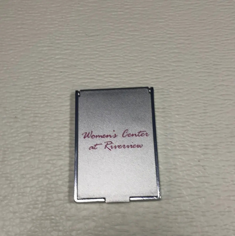 
                  
                    Women’s Compact Mirror. Closable, Labeled Women's Center at Riverview.
                  
                